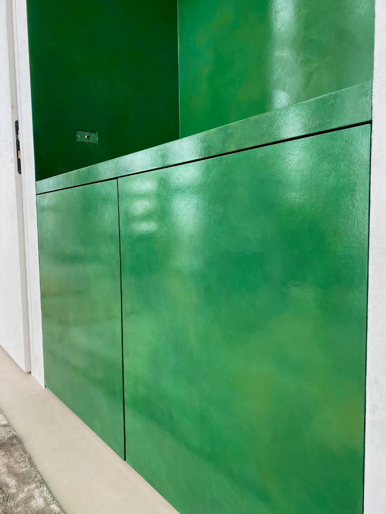 Close detail — polished green surface holding reflected light.