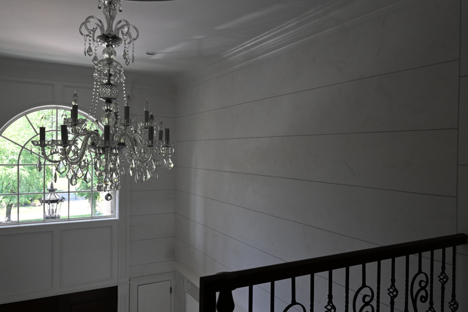 Polished Venetian plaster with scored horizontal reveals.