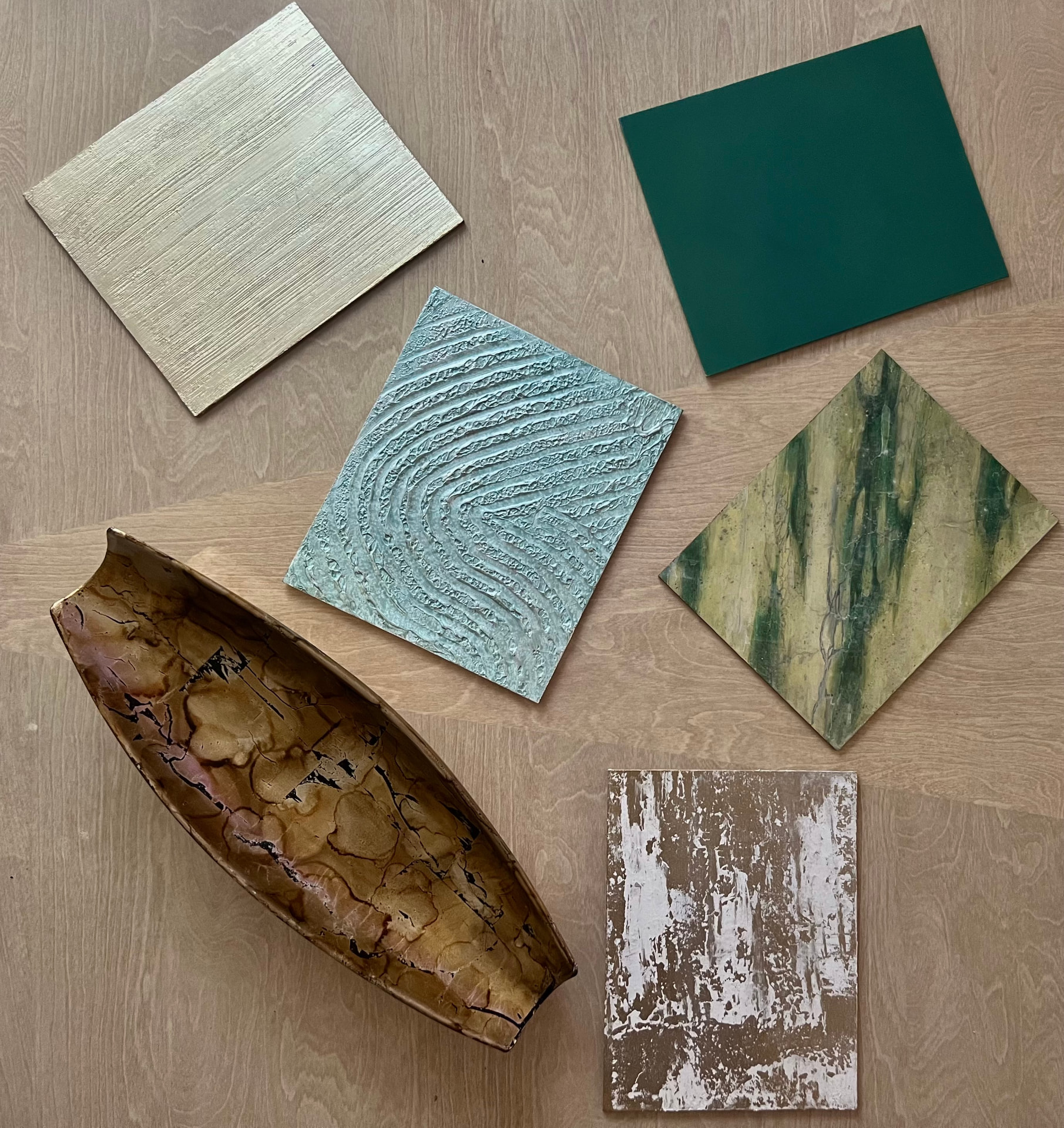 Handcrafted finish sample boards arranged on a studio table