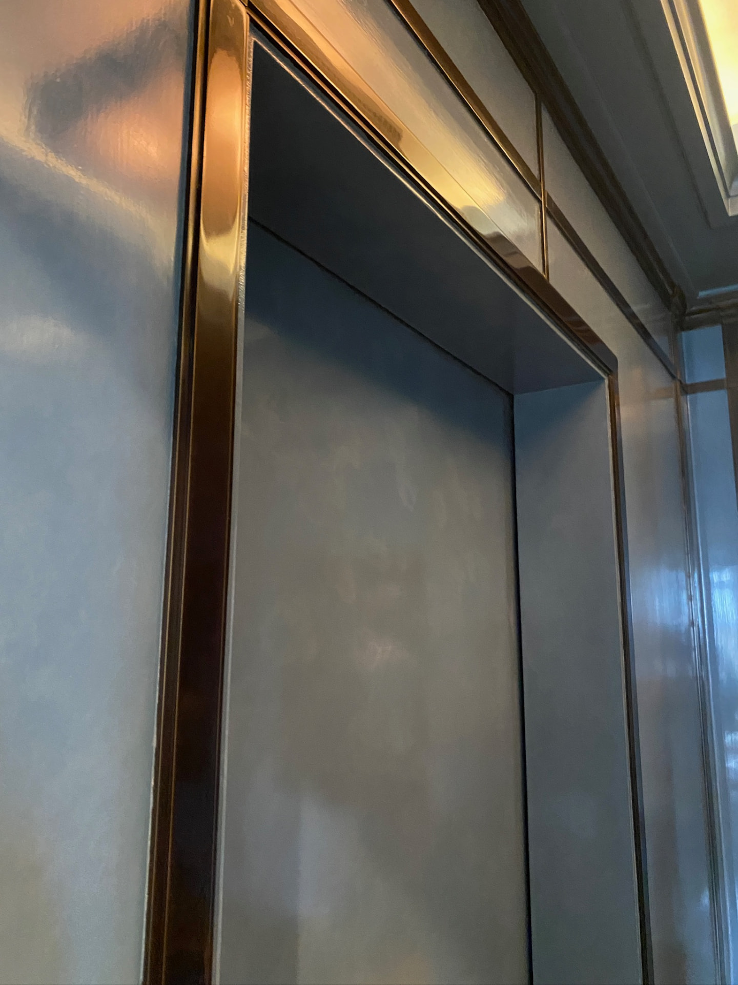 Polished panels and bronze reveal at the door head.