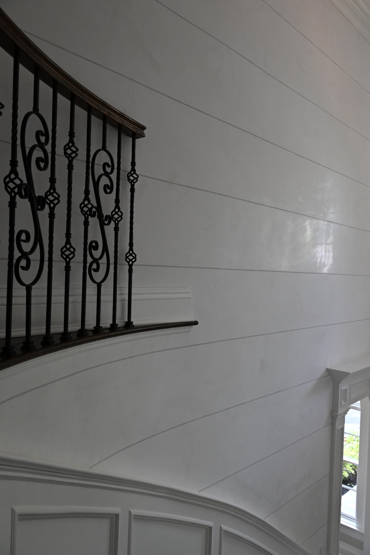 Stair hall detail — continuous plaster around the curve.